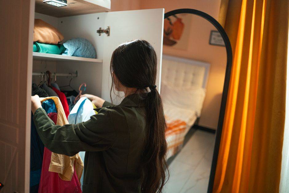 Woman organizing clothes in a custom closet